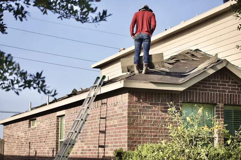 Professional roofer working on a residential roof in New Canton